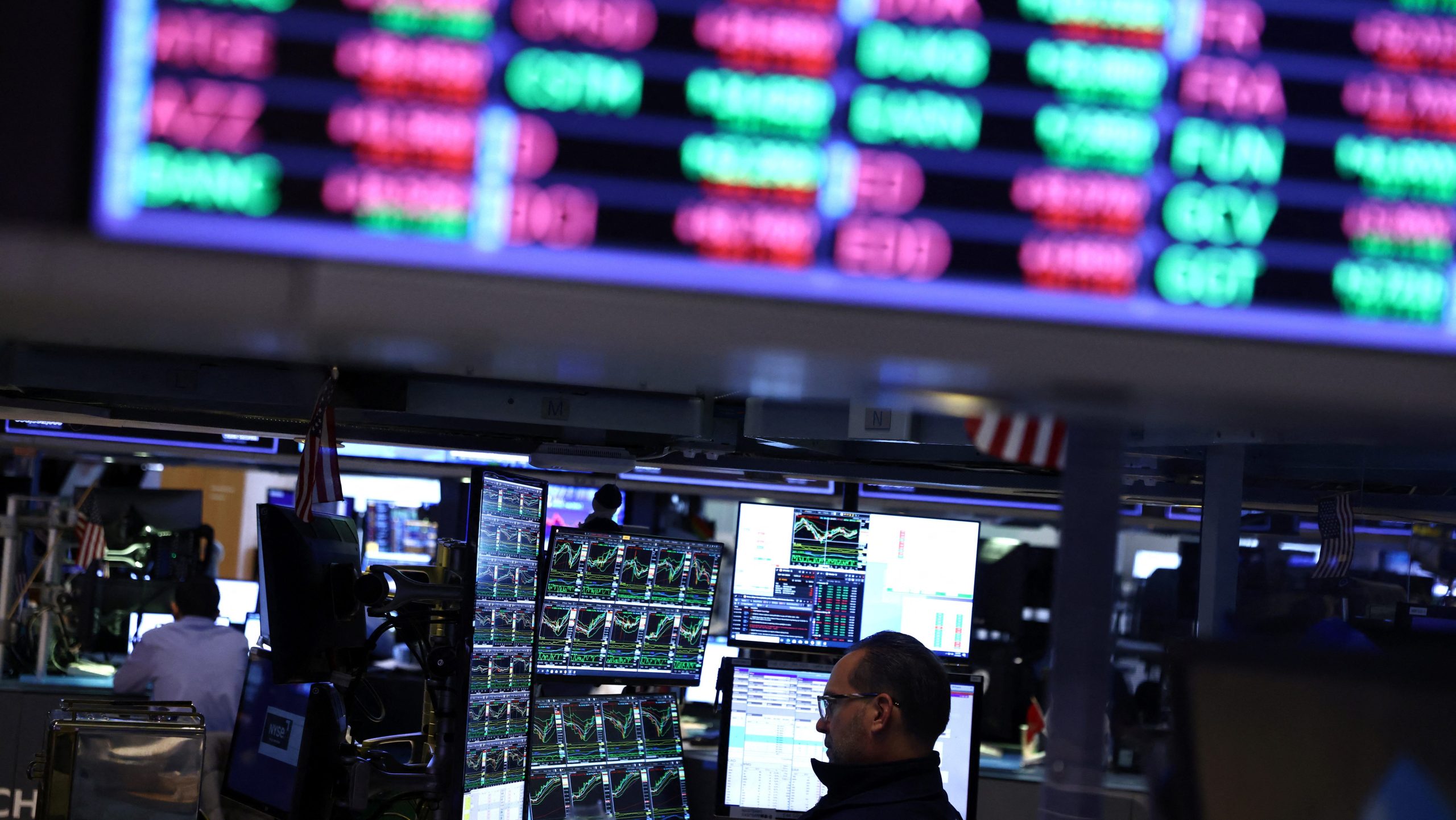 Traders work on the trading floor at the New York Stock Exchange (NYSE) in New York City
