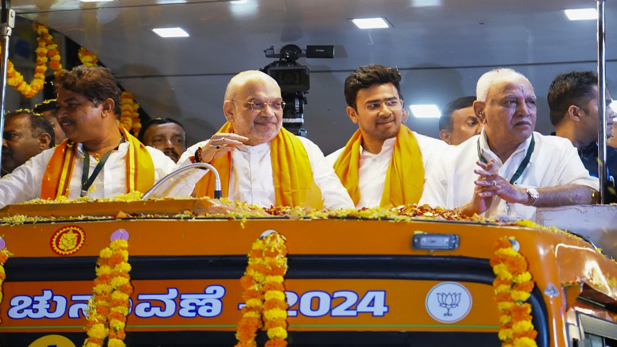 Union Home Minister Amit Shah with BJP's Bengaluru South candidate Tejasvi Surya and former Karnataka CM BS Yediyurappa during a roadshow for Lok Sabha polls, in Bengaluru,Tuesday, April 23, 2024. (PTI Photo)